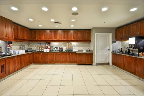 a large kitchen with wooden cabinets and a white tile floor at Residence Inn Saint Louis O'Fallon in O'Fallon