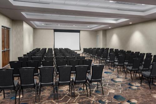 a conference room with chairs and a white screen at Residence Inn Bethesda Downtown in Bethesda