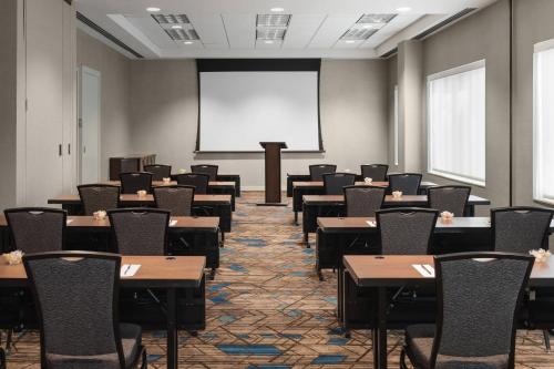 a room with tables and chairs and a projection screen at Residence Inn Bethesda Downtown in Bethesda