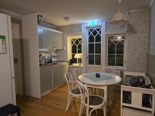 a kitchen and dining room with a table and chairs at Sofielund Vandrarhem & Camping in Sala