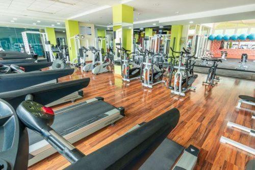 a gym with rows of treadmills and machines at Emmaus in Cartagena de Indias
