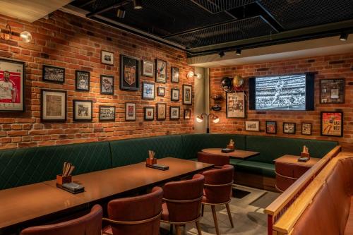 a restaurant with tables and chairs and a brick wall at Munich Marriott Hotel in Munich