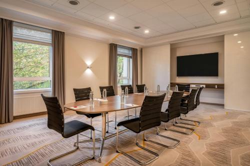 a conference room with a table and chairs at Munich Marriott Hotel in Munich