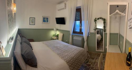 a bedroom with a large bed and a mirror at B&B dalLo Zio in Ottobiano