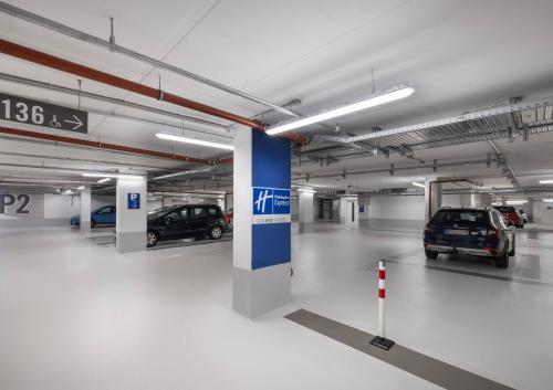 a parking garage with two cars parked in it at Holiday Inn Express Munich City West by IHG in Munich