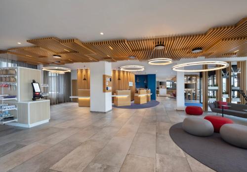 a lobby of a store with couches and tables at Holiday Inn Express Munich City West by IHG in Munich