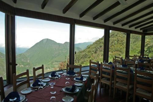 a dining room with a table with a view of mountains at El Crater in San Antonio