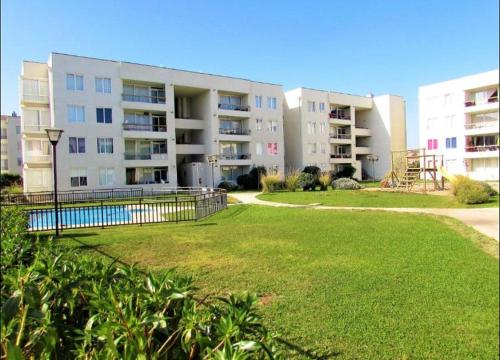 a large apartment building with a lawn in front of it at Depto 941 in La Serena