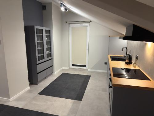 a kitchen with a sink and a counter top at Apartamenty N, Trąbki in Wieliczka