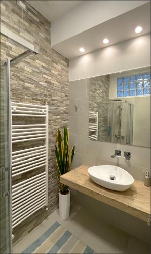 a bathroom with a sink and a shower and a mirror at Lungomare 70 in Marzocca di Senigallia