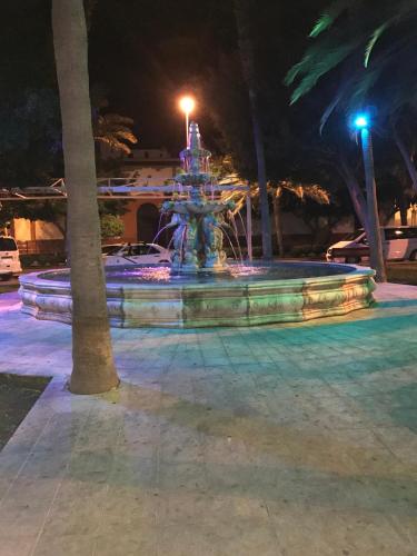 a fountain in a park at night at Amazing Sea View apartment with sun drenched terrace! in Gran Tarajal