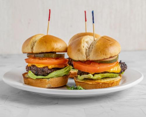 three hamburgers on a plate on a table at Holiday Inn Rock Hill by IHG in Rock Hill