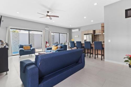 a living room with a blue couch and a kitchen at Casa Bella Vacation Home in Puerto Vallarta