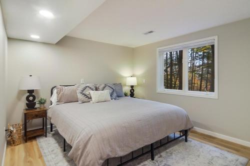 a bedroom with a bed and a window at Luxury Estate Overlooking Water in Traverse City