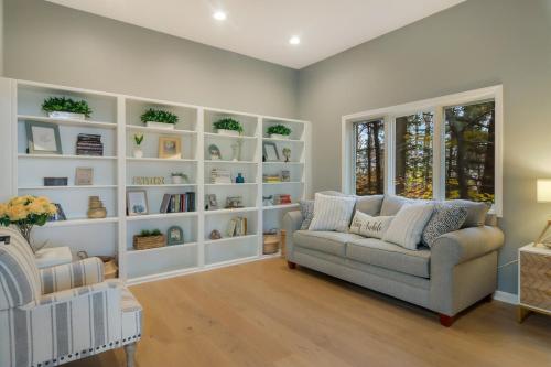 a living room with a couch and book shelves at Luxury Estate Overlooking Water in Traverse City