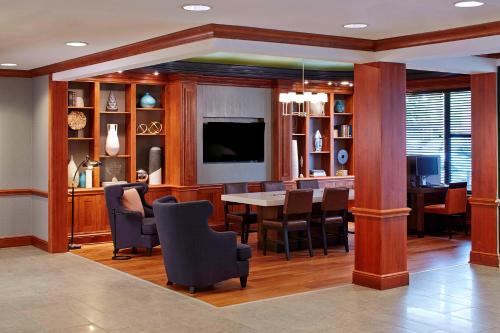 a dining room with a table and chairs and a television at Residence Inn Minneapolis Downtown at The Depot in Minneapolis