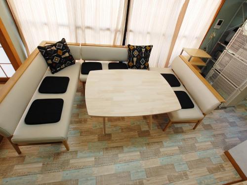 a room with a bed and a table and chairs at 東京の中心地 Okachimachi Staypia in Tokyo