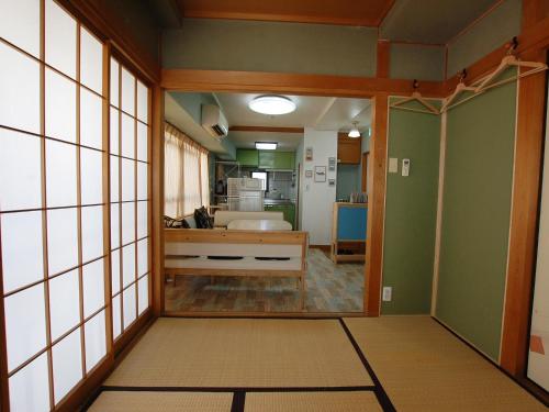 a room with a hallway with a mirror and a kitchen at 東京の中心地 Okachimachi Staypia in Tokyo