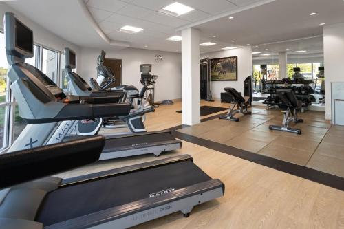 a gym with treadmills and elliptical machines at Holiday Inn & Suites - Savannah Airport - Pooler by IHG in Savannah
