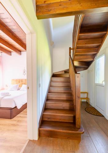a staircase leading to a bedroom with a bed at Casa Rural Orós in Orós Alto