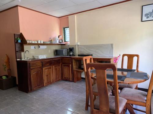 a kitchen with a table and a counter with a sink at Globi Lodge #3 in Monteverde Costa Rica