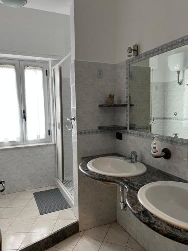 a bathroom with two sinks and a shower at Stella Marina Home Holidays in Gioia Tauro
