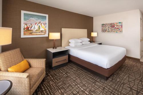 a hotel room with a bed and a chair at DoubleTree by Hilton Ontario Airport in Ontario
