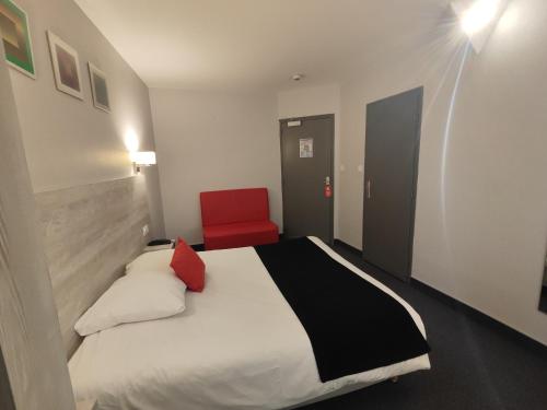 a bedroom with a bed and a red chair at Campanile Grenoble Centre Gare in Grenoble