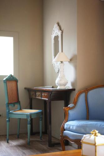 a room with a table and a chair and a mirror at Campo Di Fiori, Maisons de Charme in Calvi