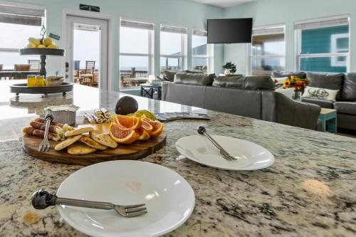 a table with two plates of food on a counter at Jolly Roger - Themed Beachfront 5BR with Arcade in Gilchrist