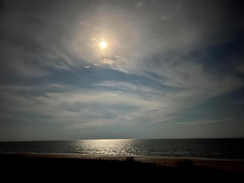 a view of the ocean with the sun in the sky at Jolly Roger - Themed Beachfront 5BR with Arcade in Gilchrist