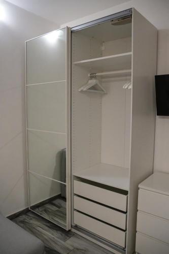 a walk in closet with a glass door at Giorgia House in Pieta