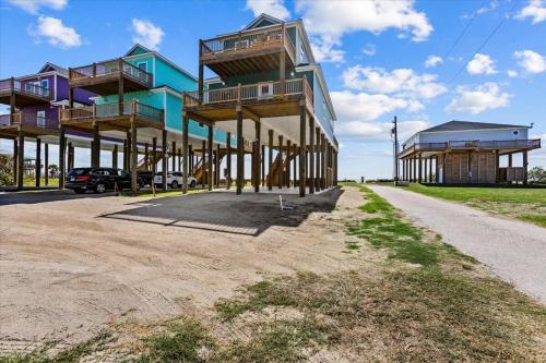 a building with balconies on the side of a road at Mimosa Beach - Luxury Beachfront 5BR, Gorgeous views from multiple Decks in Gilchrist