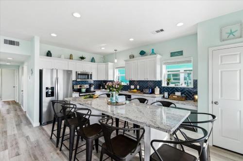 a kitchen with a large marble table and chairs at Mimosa Beach - Luxury Beachfront 5BR, Gorgeous views from multiple Decks in Gilchrist