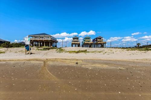 a group of houses sitting on top of a beach at Mimosa Beach - Luxury Beachfront 5BR, Gorgeous views from multiple Decks in Gilchrist