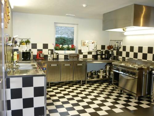 a kitchen with black and white checkered floor at Belgium your low-cost stays in luxury gites in Hamoir