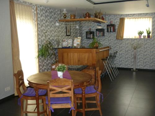a dining room with a wooden table and chairs at Belgium your low-cost stays in luxury gites in Hamoir