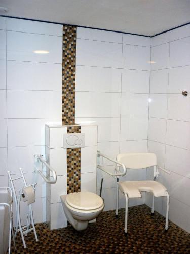 a bathroom with a toilet and chairs in it at Belgium your low-cost stays in luxury gites in Hamoir