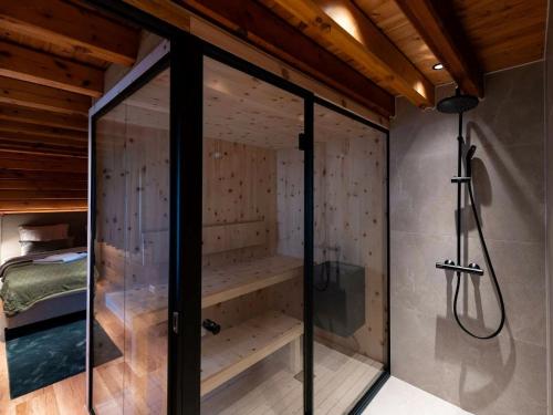a glass shower in a room with a bed at Lodge in Buntenbock in Flussnähe in Clausthal-Zellerfeld