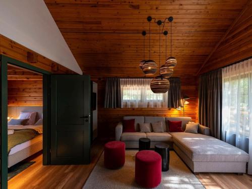 a living room with a couch and a bed at Lodge in Buntenbock in Flussnähe in Clausthal-Zellerfeld