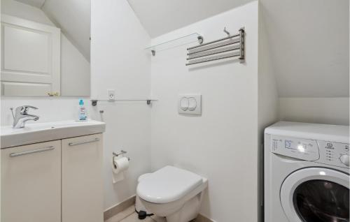 a white laundry room with a washer and dryer at Two-Bedroom Apartment In Grasten in Gråsten
