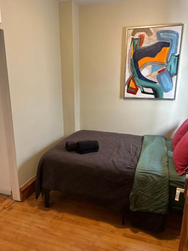 a bed in a room with a painting on the wall at Dorothy's in Chicago