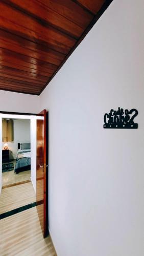 a room with a door leading to a bedroom at Cantinho Dona Cleide in Monte Verde