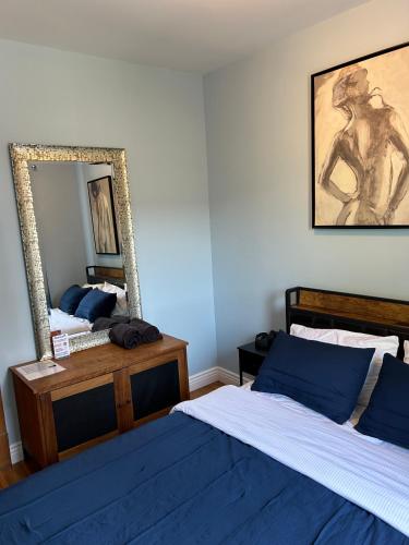 a bedroom with two beds and a mirror at Dorothy's in Chicago