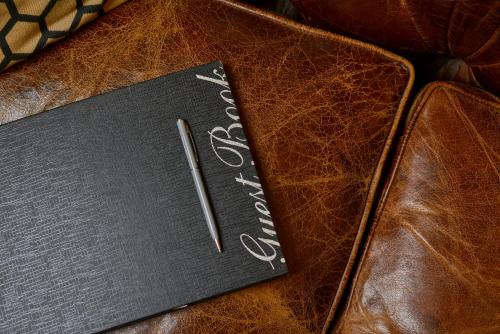 a notebook with a pen on top of a table at The Russell Boutique Hotel in Sydney
