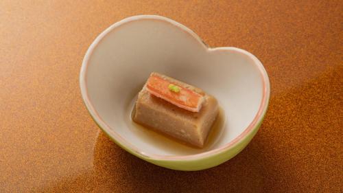a heart shaped bowl with a piece of food in it at Fujisan Ryokan in Hanamaki