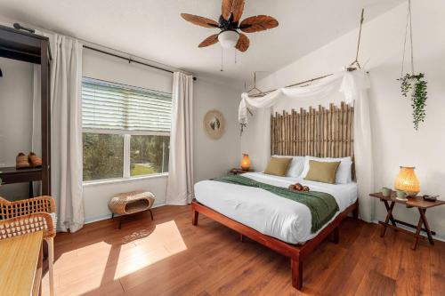 a bedroom with a large bed and a window at Bali Bliss at Oaks - Full Kitchen , Near I75 in Gainesville