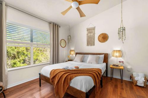 a bedroom with a bed and a large window at Bali Bliss at Oaks - Full Kitchen , Near I75 in Gainesville