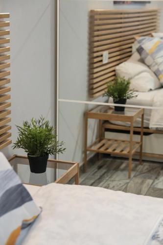 a bedroom with a bed and two potted plants at Giorgia House in Pieta