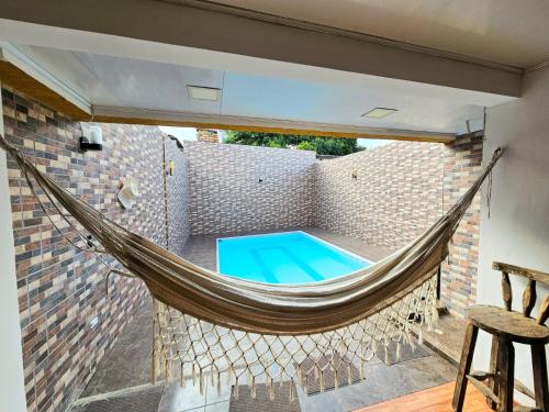 a hammock on a patio with a swimming pool at CASA QUINTA EL PARAiSo EN MESITAS DEL COLEGIO in El Colegio